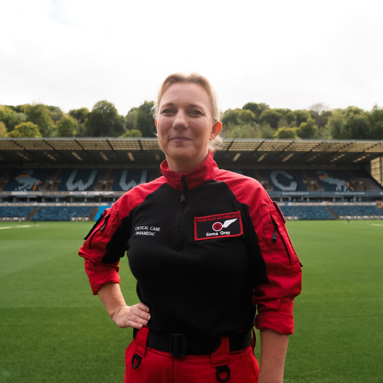 Critical Care Paramedic Emma stands on the Wycombe Wanderers FC pitch