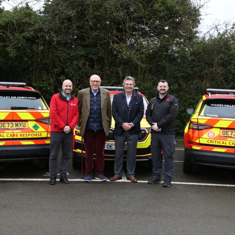 Representatives from the HELP Appeal and Thames Valley Air Ambulance in front of donated cars
