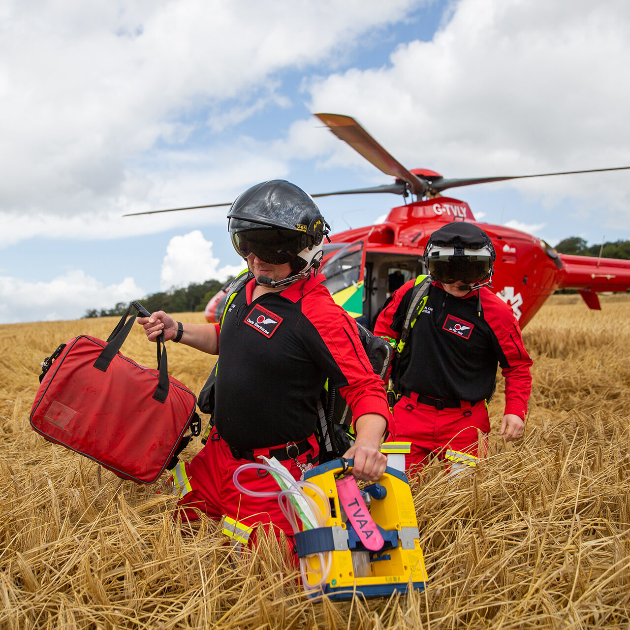 Thames Valley Air Ambulance crew members leaving the helicopter