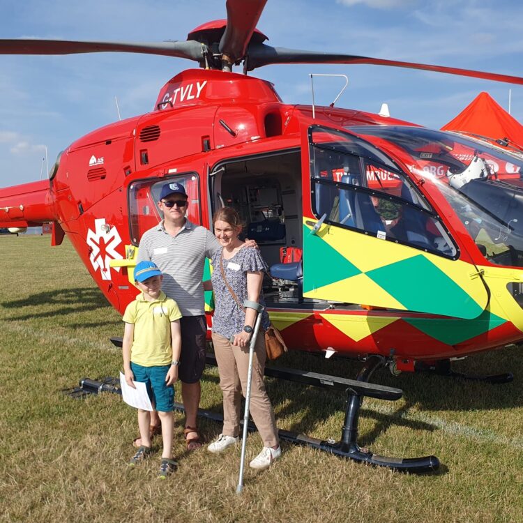 Stephanie Thorp and her family stand in front of the Thames Valley Air Ambulance helicopter